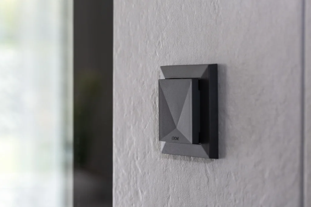Loxone Tree room comfort sensor mounted on a wall in a residential interior